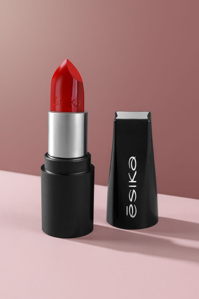 ours-journey Vibrant red lipstick with cap, presented on soft pink and maroon background.