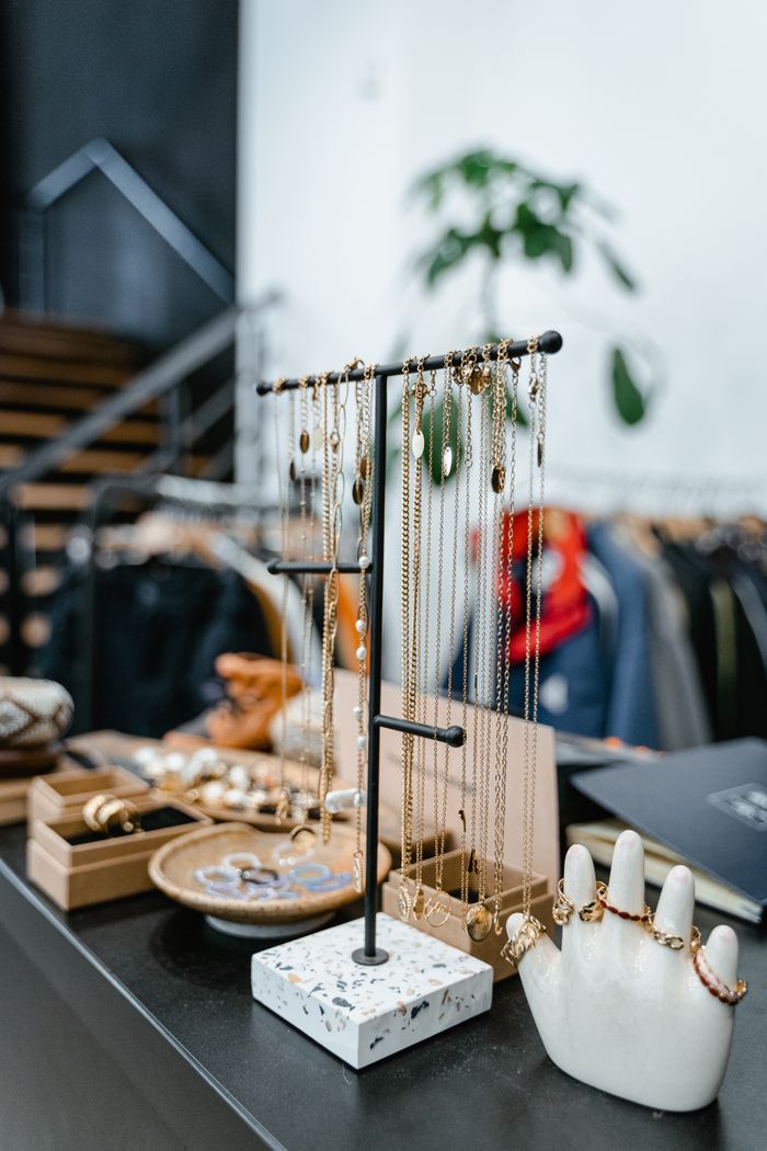 our-experience Chic jewelry presentation in a stylish boutique setting with necklaces and rings on display.